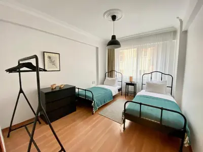 a bedroom with two beds and a dresser in it at Central & Spacious Flat - No5 in Istanbul