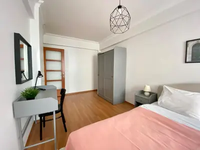 a bedroom with a bed and a desk and a chair at Central & Spacious Flat - No5 in Istanbul