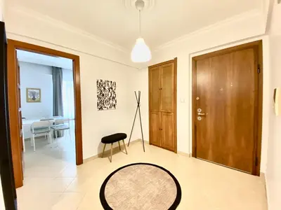 a living room with a table and a wooden door at Central & Spacious Flat - No5 in Istanbul