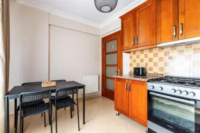 a kitchen with a table and a stove top oven at Gorgeous 3 Bedroom Flat - No8 in Istanbul