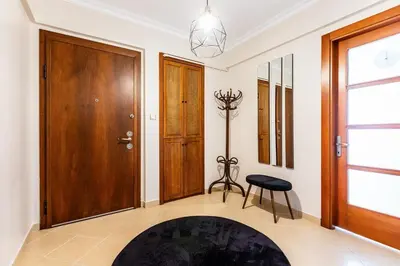 a hallway with a wooden door and a stool at Gorgeous 3 Bedroom Flat - No8 in Istanbul
