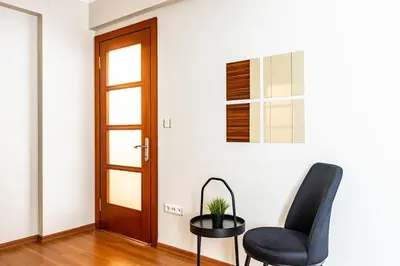 a living room with a black chair and a table at Gorgeous 3 Bedroom Flat - No8 in Istanbul