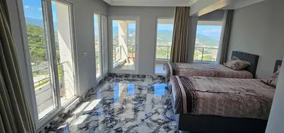 a room with two beds and large windows at Luxury villa with sea and forest view in Döngel