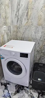 a washing machine sitting next to a stone wall at Luxury villa with sea and forest view in Döngel