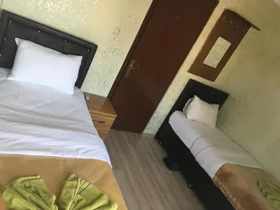 a hotel room with two beds with white sheets at Şebnem Hotel in Istanbul