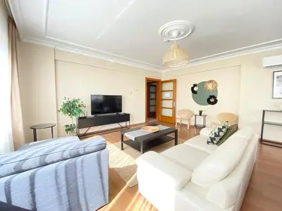 a living room with white furniture and a flat screen tv at City Center Spacious Flat No9 in Istanbul