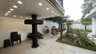 a patio with chairs and a heater in a building at Luxury Skylights Villa in Kullar