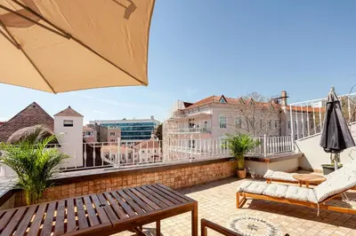 a balcony with a table and chairs and an umbrella at Roof top, close to Taksim, with private terrace in Istanbul