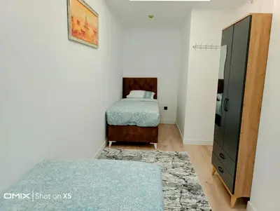 a bedroom with a bed and a dresser in it at Luxury Rezidans in Istanbul