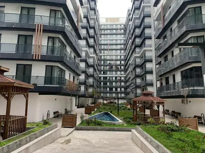 a courtyard with a gazebo in front of a tall building at Luxury Rezidans in Istanbul