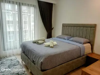 a bedroom with a bed with two stuffed animals on it at Luxury Rezidans in Istanbul