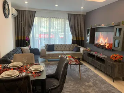 a living room with a couch and a tv at Luxury Rezidans in Istanbul