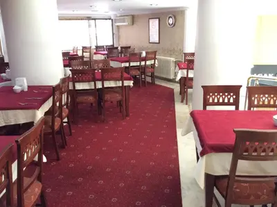 a dining room with red tables and chairs in a restaurant at Ilıcak Hotel in Istanbul