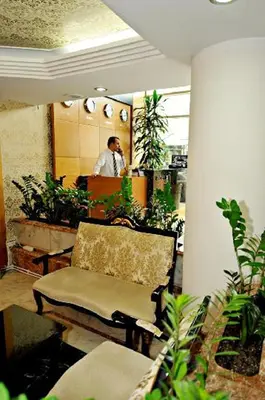 a man standing in a room with potted plants at Ilıcak Hotel in Istanbul
