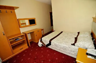 a bedroom with a bed and a desk and a mirror at Ilıcak Hotel in Istanbul