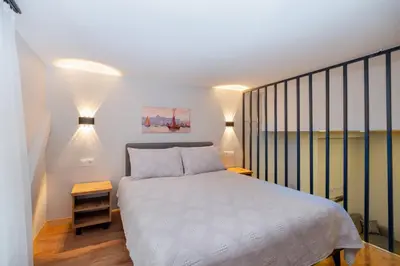 a bedroom with a white bed and two lamps at The Han YK Hotel in Avcılar