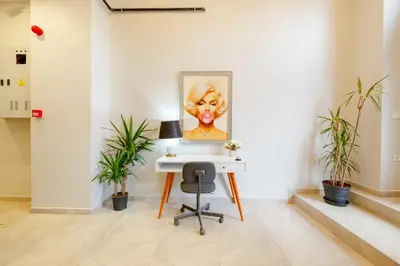 an office with a desk and a painting of a woman at The Han YK Hotel in Avcılar