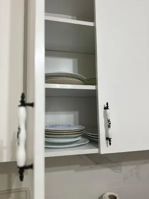 a cupboard with plates and dishes in it at Hostel Nelly in Istanbul