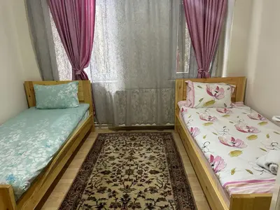 two beds in a room with a window at Hostel Nelly in Istanbul