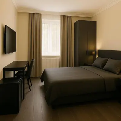 a bedroom with a bed and a desk and a window at Redka Bungalov Resort in Ulupelit