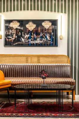 a brown leather bench in a room with a picture at Sistina Old City Hotel in Istanbul