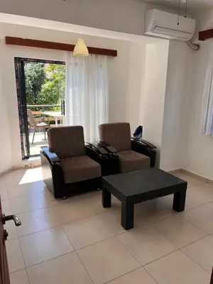 a living room with two chairs and a coffee table at Enn Is Inn Hotel in Marmaraereglisi