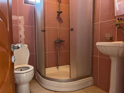 a bathroom with a shower and a toilet and a sink at Enn Is Inn Hotel in Marmaraereglisi
