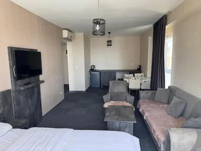 a hotel room with a couch and a tv at Pin Suite in Buyukcekmece