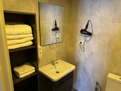 a bathroom with a sink and a mirror and towels at Pin Suite in Buyukcekmece