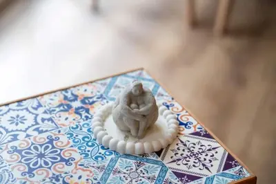 a figurine of a person sitting on a table at Boho-Chic 1BR in Firuzaga - Near Galata in Istanbul