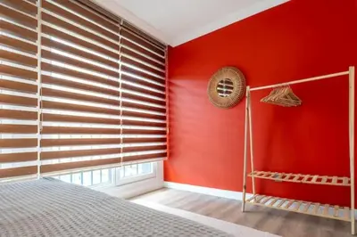 a bedroom with red walls and a bed and a window at Boho-Chic 1BR in Firuzaga - Near Galata in Istanbul