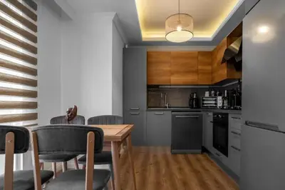 a kitchen with a wooden table and chairs at Boho-Chic 1BR in Firuzaga - Near Galata in Istanbul