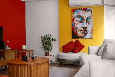 a living room with a couch and a painting on the wall at Boho-Chic 1BR in Firuzaga - Near Galata in Istanbul