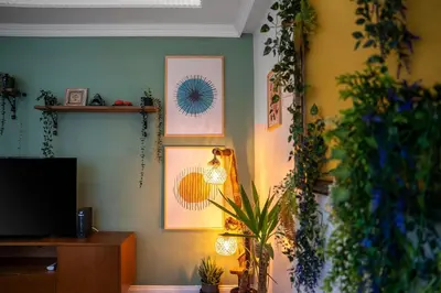 a living room with plants and pictures on the wall at Forest Inspired Designed 1BR Luxury Flat In Tomtom in Istanbul