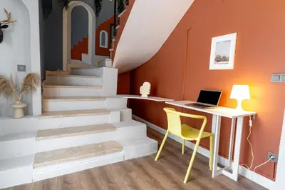 a stair room with a desk and a laptop on a table at Luxury 1BR Duplex with Terrace & Office in Tomtom in Istanbul