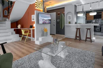 a living room with a glass table and a kitchen at Luxury 1BR Duplex with Terrace & Office in Tomtom in Istanbul