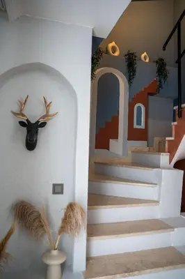 a house with a deer head on the wall and stairs at Luxury 1BR Duplex with Terrace & Office in Tomtom in Istanbul