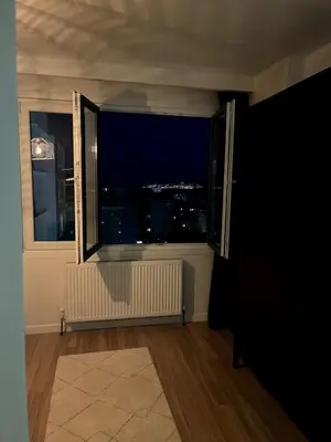a room with a window with a view of a city at night at Istanbul Bostanci Family Modern Residence with Pool in Istanbul