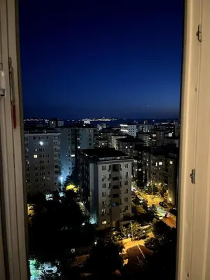 a view of a city at night from a window at Istanbul Bostanci Family Modern Residence with Pool in Istanbul