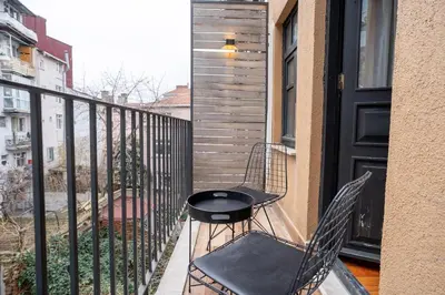 a balcony with two chairs and a table on it at Designed 2BR Rooftop Duplex with Private Terrace in Istanbul