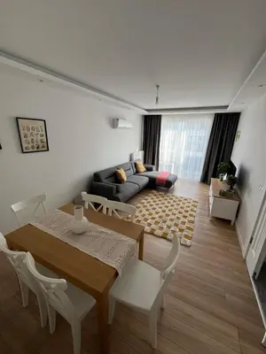 a living room with a table and a couch at Köylüm Bostanci Residence-3 in Istanbul