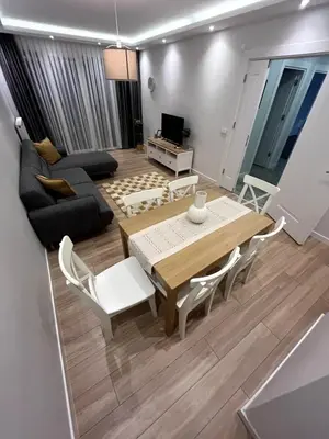 a living room with a table and a couch at Köylüm Bostanci Residence-3 in Istanbul