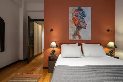 a bedroom with a bed and a painting on the wall at Charming 1BR Flat with Balcony in Cihangir in Istanbul