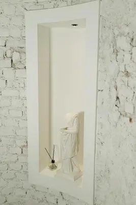 a mirror on a wall with a statue in it at Magnova Studios in Istanbul