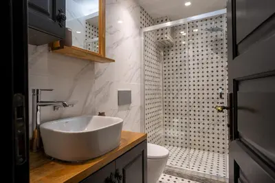 a bathroom with a white sink and a shower at Cozy Urban 1BR Nest with Balcony Charm in Istanbul