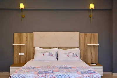 a bedroom with a large bed with two pillows at ADASU Otel in Marmara