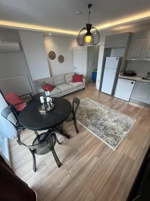 a living room with a table and a couch at Suadiye Bostanci Luxury 2 Bedroom Apartment with Pool in Istanbul