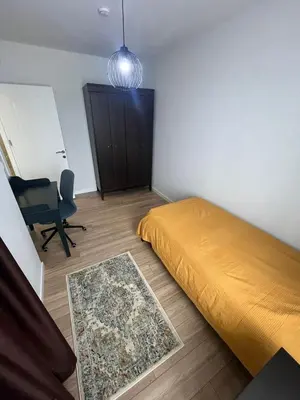 a bedroom with a bed and a chair in it at Suadiye Bostanci Luxury 2 Bedroom Apartment with Pool in Istanbul
