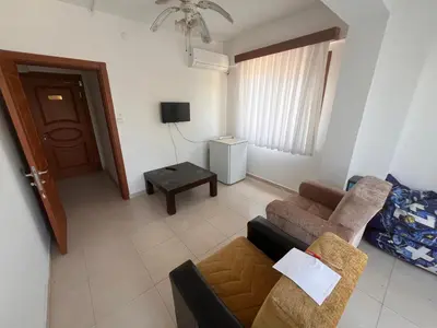 a living room with a couch and a table at Ennis İnn Resort Hotel in Marmaraereglisi