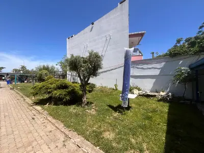 a blue pipe sitting in the grass next to a building at Ennis İnn Resort Hotel in Marmaraereglisi